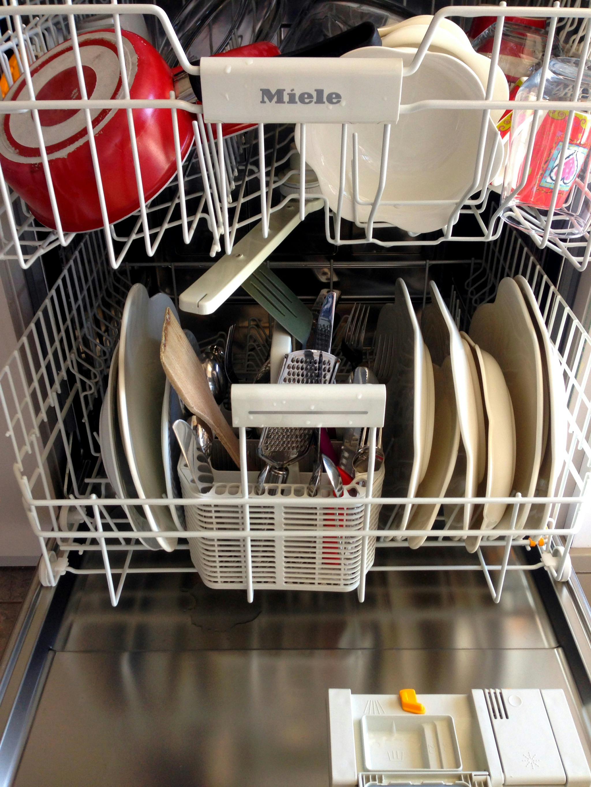 Dishes arranged inside a dishwasher before a hot wash cycle for hygienic cleaning